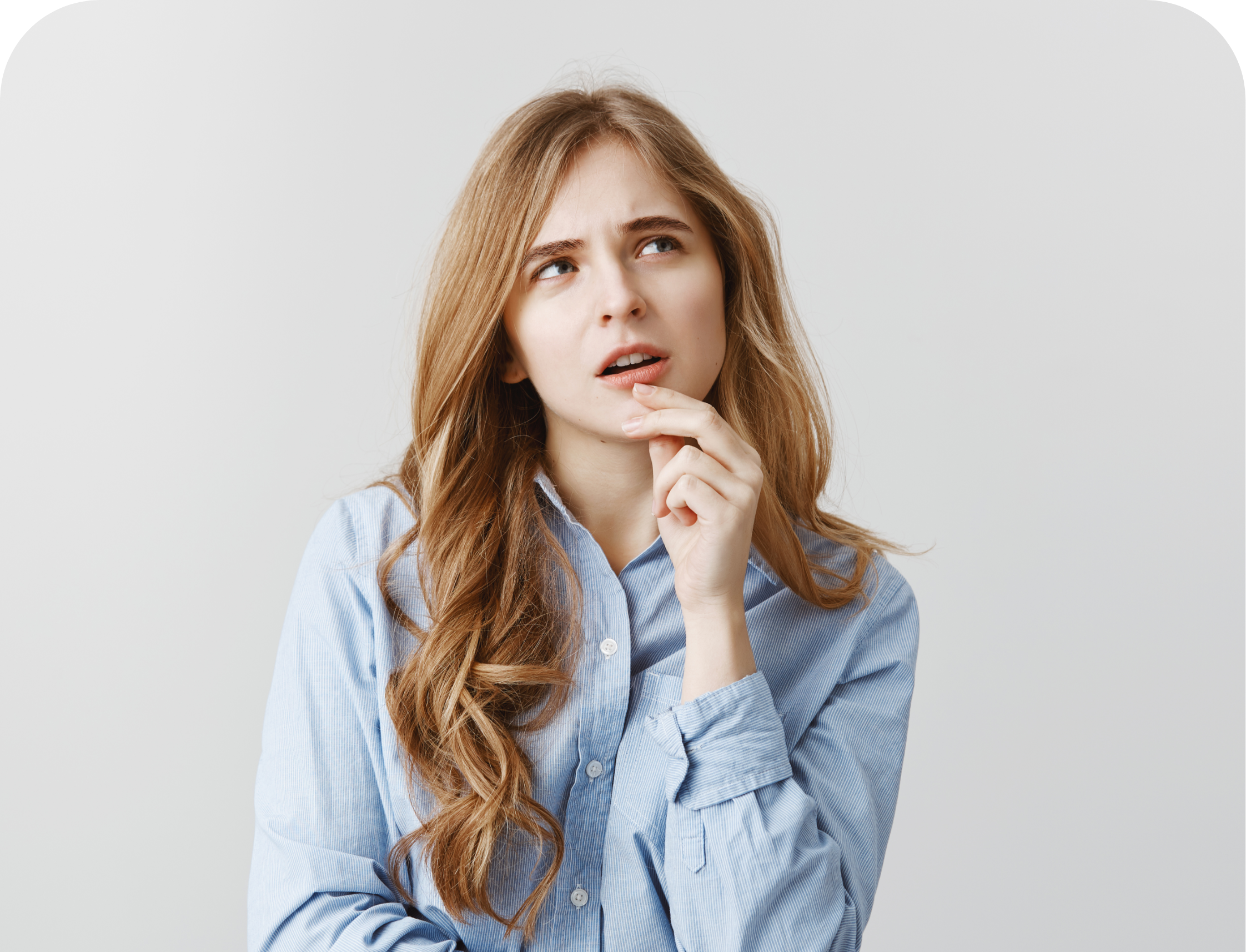 woman with hand on her chin thinking while looking off to the side