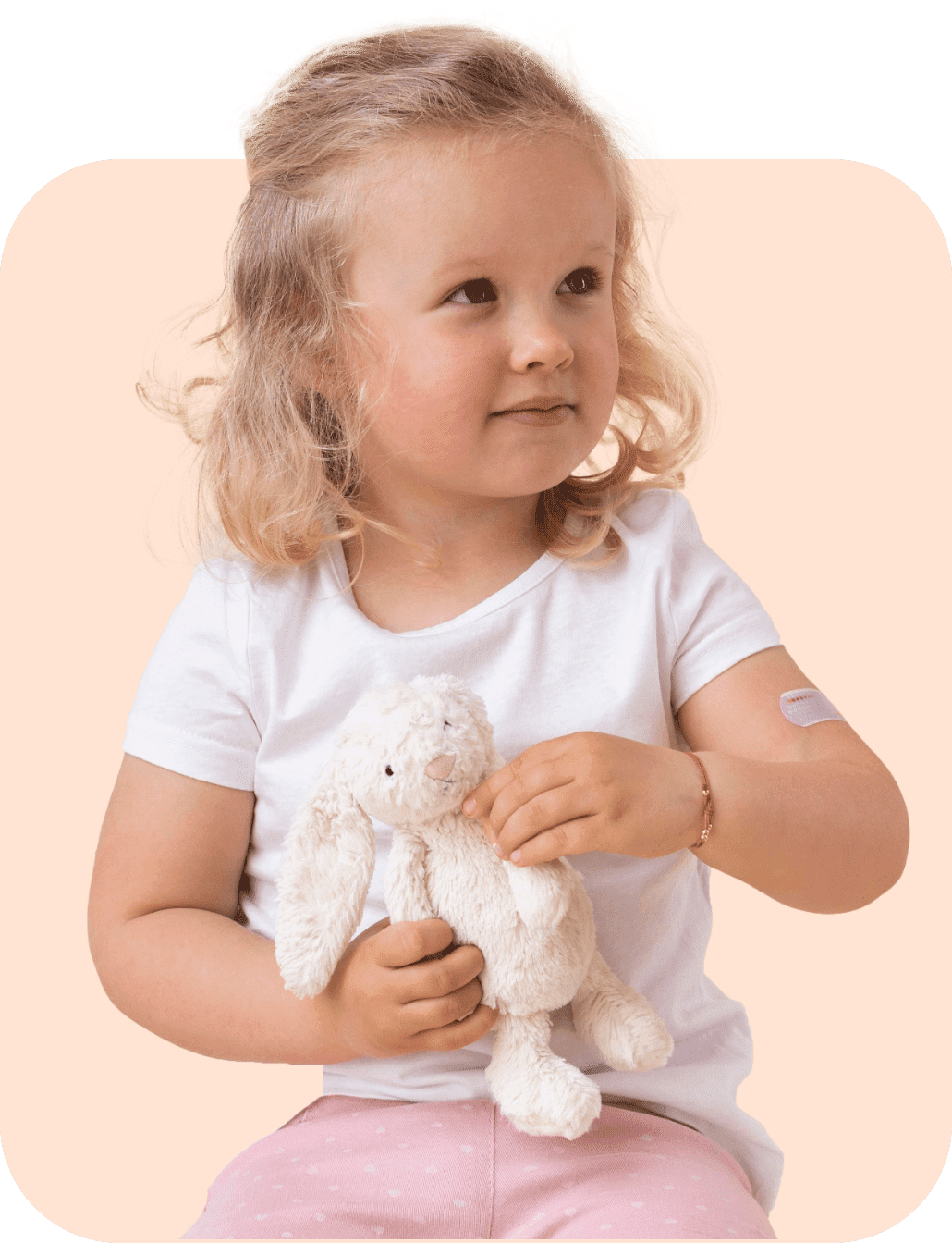 young child holding plush bunny