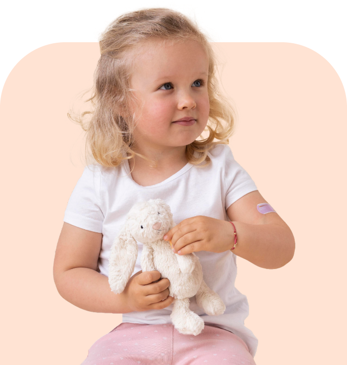 young child holding plush bunny